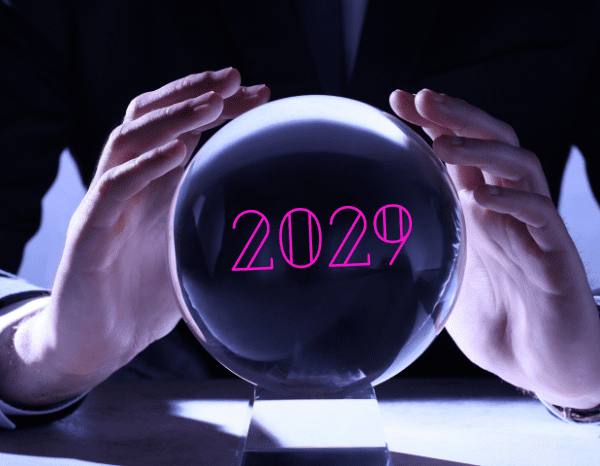 A crystal ball with the year 2029 on it with someone's hands hovering over the crystal ball.